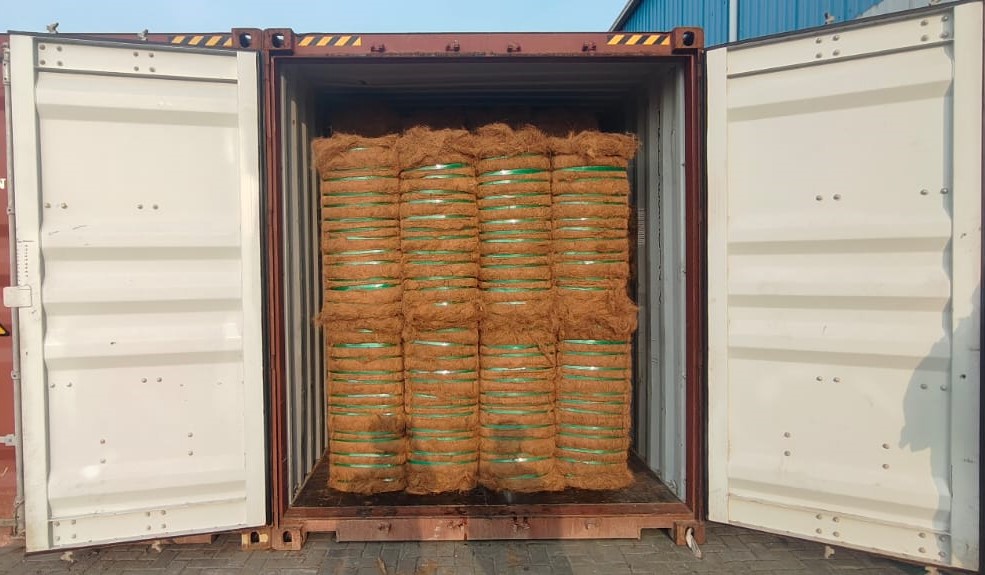 Coir bales stuffed in container — neat arrangement