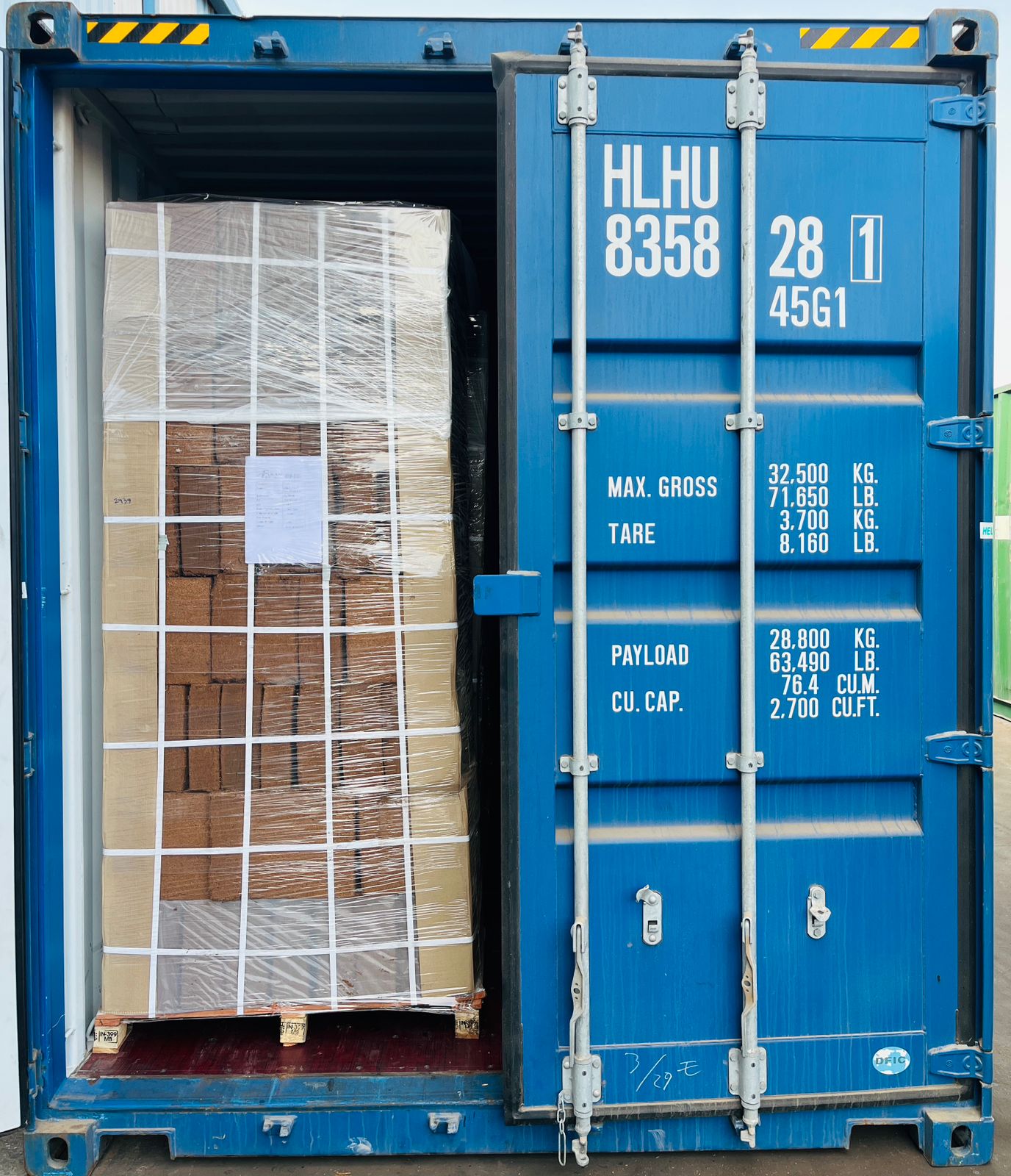 Palletized cartons inside a blue container